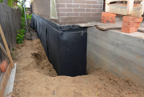 SJ Waterproofing Pros technician performing targeted Wet Basement Repair assessment in La Fontaine, IN